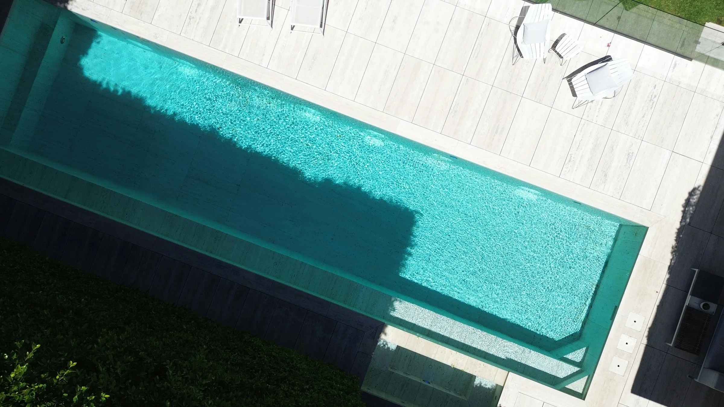 Aerial view of a modern rectangular pool and patio